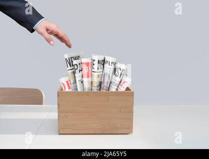 newspapers in wooden box on table. Front view Stock Photo