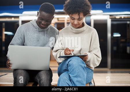 cute young couple with a digital tablet sitting in a subway car. Stock Photo
