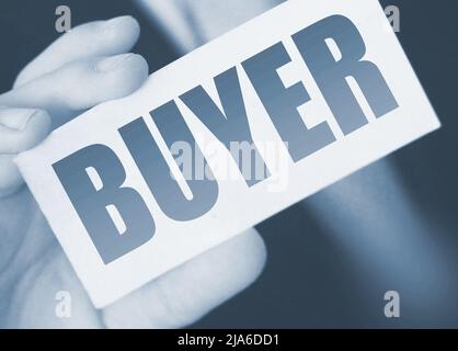 Buyer word on the card shown by a man. Customer business concept. Stock Photo