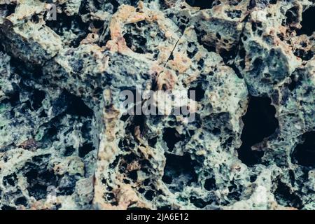 Abstract nature real photo background. Macro close up details dry rock crack stone solid foamy formations or lava volcanic, pumice texture ancient Stock Photo