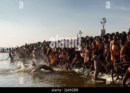 Naga sadhus enter the holy waters of the Ganges river during the Kumbh Mela festival. Every twelve years, millions of Hindu devotees begin a massive pilgrimage to the most sacred of Indian festivals: the Kumbha Mela, which takes place in Prayagraj, a place considered particularly auspicious because it is at the confluence of the Ganges, Yamuna and the mythical Saraswati. It is estimated that in 2019, 120 million people attended the sacred enclosure over the course of a month and a half. These numbers, equivalent to the total population of Japan, and 40 times the number of pilgrims who visit Me Stock Photo