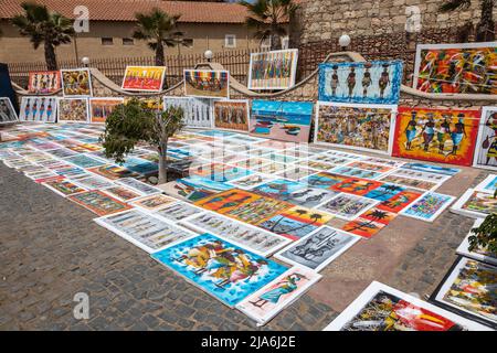 Bright African artwork / paintings for sale displayed in a street in Santa Maria, Sal, Cape Verde Island, Cabo Verde Islands, Africa Stock Photo