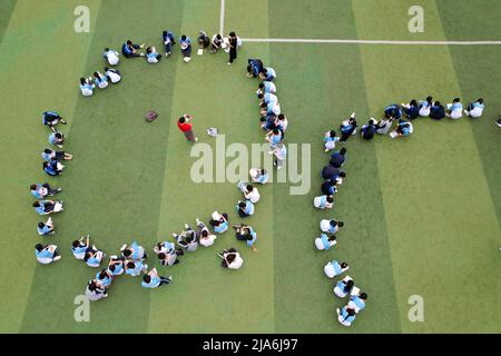 QIANDONGNAN, CHINA - MAY 27, 2022 - Aerial photo taken on May 27, 2022 shows middle school students holding an activity to relieve stress before the n Stock Photo