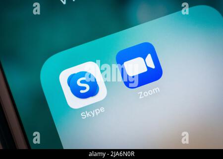 Kumamoto, Japan - Feb 16 2021 : Skype (telecommunications app that specializes in video chat, voice calls and instant message) with Zoom app on iPhone Stock Photo