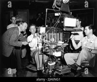 Cinematographer WILLIAM H. DANIELS with Camera Crew on set candid during filming of SO ENDS OUR NIGHT 1941 director JOHN CROMWELL from novel Flotsam by Erich Maria Remarque screenplay Talbot Jennings production design William Cameron Menzies producers Albert Lewin and David L. Loew / United Artists Stock Photo