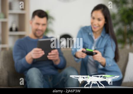 happy couple using modern drone Stock Photo