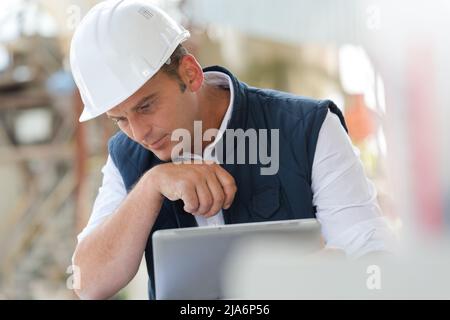 handsome male engineer is using a notebook for work Stock Photo