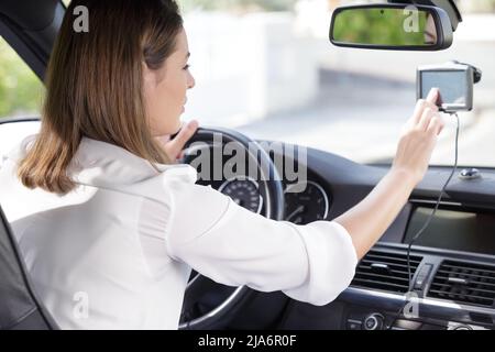 woman using gps navigation system in car Stock Photo