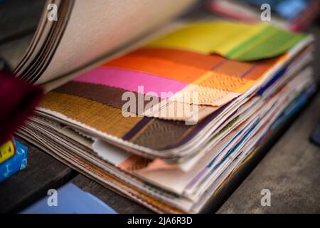 Cloth fabric book - Cotton thread and seeds textiles garments Stock Photo