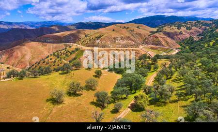 Above view of endless mountains in spring with lush green trees Stock Photo