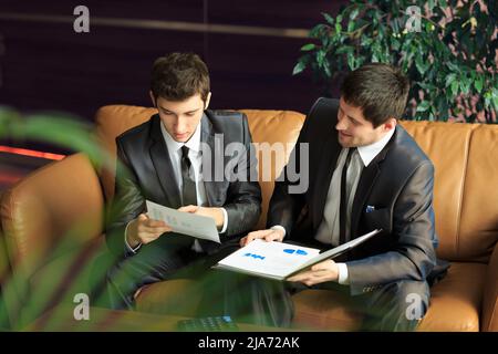 Image of two young businessmen discussing project at meeting Stock Photo