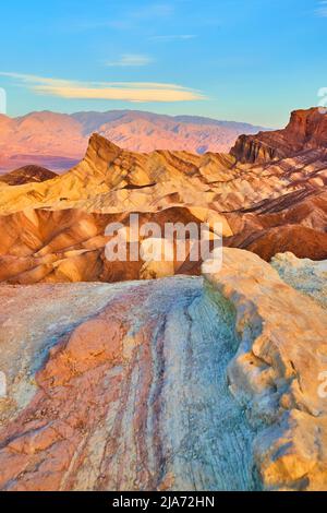 Death Valley waves of colors in mountains at sunrise Stock Photo
