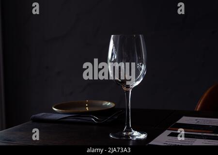 Elegant table setting at restaurant with a plate, glass and menu Stock Photo