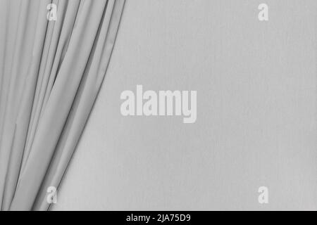 Grey curtain against the background of an empty gray wall interior decoration background modern design. Stock Photo