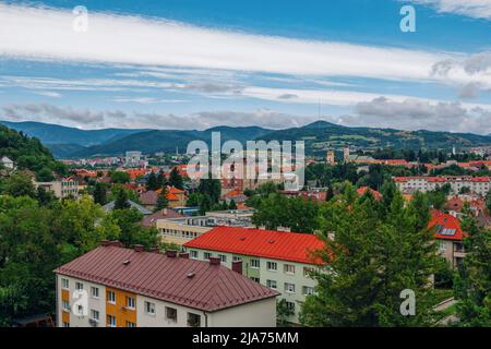 Banska Bystrica, Slovakia – August 17, 2021: aerial summer cityscape – colorful buildings, green hills on the horizon and blue sky Stock Photo