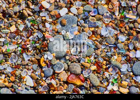 Beach pebbles of smooth colorful rocks covering coast Stock Photo