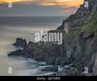 The ruins of the Botallack Tin Mines, located on the rugged Cornish coast, near Lands end. Long exposure to smooth out the sea. Stock Photo