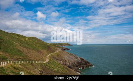 The Welsh Coastal path, winding its way around a headland on the Gower peninsular, on a sunny, spring day Stock Photo