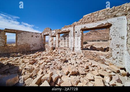 Inside abandoned Rhyolite building with names carved on walls Stock Photo