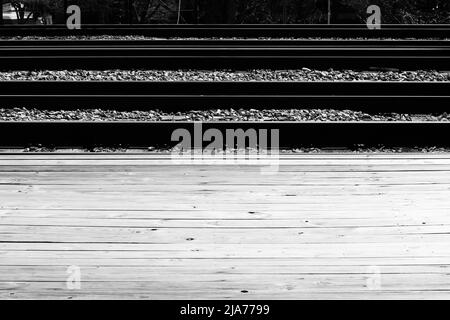 Typical common railroad tracks crossing the plains on a bright sunny day in black and white. Stock Photo