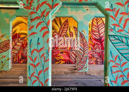 Beautiful and colorful feather graffiti covers cement arches under bridge Stock Photo