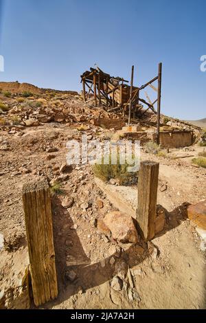 Entrance to old abandoned mining equipment in hillside of Death Valley Stock Photo