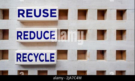 Environmental awareness and educational concept. REUSE, REDUCE and RECYCLE written on wooden blocks. Stock Photo