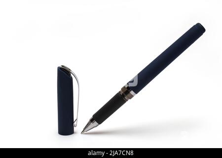 Close up of high quality dark blue pen with metal tip and cap with silver clip standing next to it on white background Stock Photo
