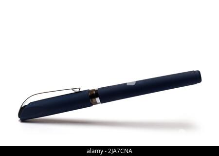 Close up of dark blue high quality pen with closed cap and silver metal clip on white background Stock Photo