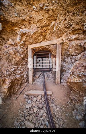 Eerie mine entrance in Death Valley with blocked entrance Stock Photo