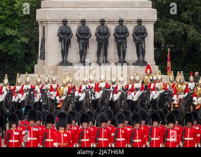 Horse Guards Parade, London, UK. 28 May 2022. The Colonel’s Review takes place, reviewed by HRH the Duke of Cambridge, and is the final rehearsal for Trooping the Colour which will take place on a weekday - Thursday 2nd June - for the Platinum Jubilee year. This year, the honour of trooping their colour falls to the Irish Guards and as Colonel of the regiment the Duke leads the final review. Image: Guardsmen and Life Guards in front of The Guards Memorial. Credit: Malcolm Park/Alamy Live News Stock Photo