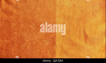 Brown suede closeup background. The texture of soft natural suede of the highest quality. Stock Photo