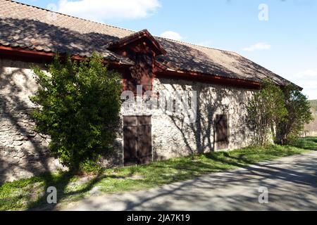 DALARNA, SWEDEN ON MAY 16, 2022. Close-up view of an old stone building. Road this side. Editorial use. Stock Photo