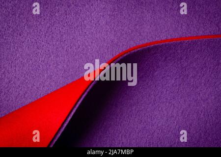 Abstract geometric felt texture background. Creative geometric curved felt textile background in red and purple colors. Top view, copy space Stock Photo