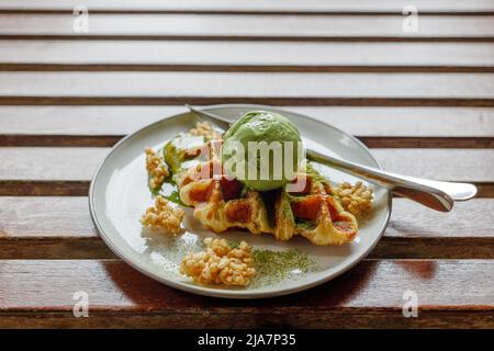 Matcha Green tea ice cream on croissant waffles. Stock Photo
