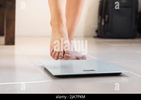 Female Bare Feet Standing On A Digital Scales. Weight Loss Stock Photo,  Picture and Royalty Free Image. Image 84250838.