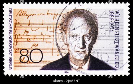 MOSCOW, RUSSIA - MAY 14, 2022: Postage stamp printed in Germany shows Wilhelm Furtwangler and sheet music, composer and conductor) 1886-1954, serie, c Stock Photo