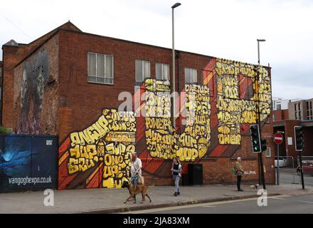 Leicester, Leicestershire, UK. 28th May 2022.  People walk past a spray painted mural during the Bring the Paint event. The award winning International Street Art Festival attracts artists from all over the world. Credit Darren Staples/Alamy Live News. Stock Photo