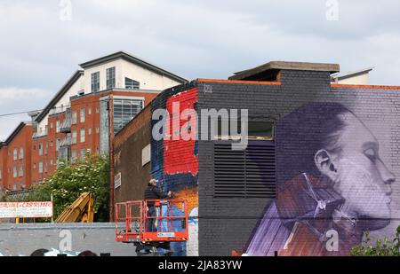 Leicester, Leicestershire, UK. 28th May 2022.  An artist spray paints a  mural during the Bring the Paint event. The award winning International Street Art Festival attracts artists from all over the world. Credit Darren Staples/Alamy Live News. Stock Photo