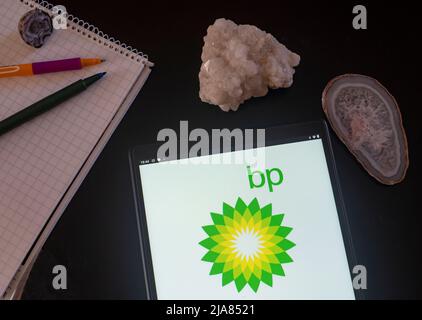 In this photo illustration BP plc (official styling BP p.l.c., formerly The British Petroleum Company plc and BP Amoco plc) logo seen displayed on a tablet Stock Photo