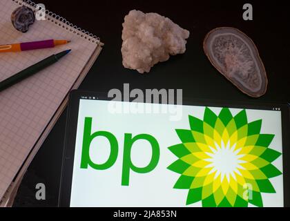 In this photo illustration BP plc (official styling BP p.l.c., formerly The British Petroleum Company plc and BP Amoco plc) logo seen displayed on a tablet Stock Photo