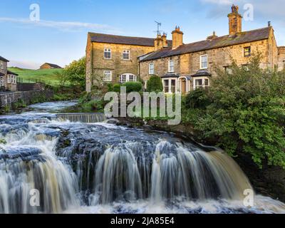 Waterfall on Gayle Beck in the centre of the Yorkshire Dales town of Hawes, Wensleydale. Taken early morning. Stock Photo