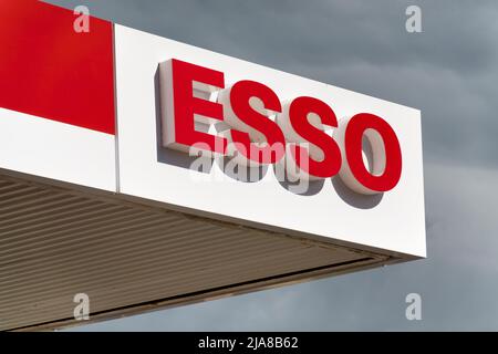 Warminster, Wiltshire, UK - MAY 24 2022: An ESSO petrol station sign with grey clouds behind it Stock Photo