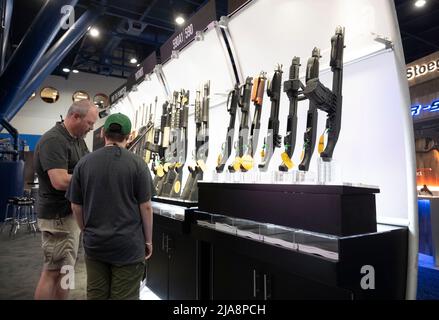 Houston, Texas United States, 28th May 2022: Gun enthusiasts shop for firearms, ammunition and outdoor products at the Mossberg booth Saturday morning at the National Rifle Association's (NRA) trade show. The exhibits cover almost 14 acres inside the George R. Brown Convention Center. Credit: Bob Daemmrich/Alamy Live News Stock Photo