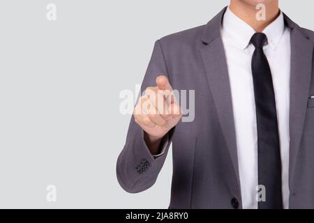 Young businessman pointing with finger for advertisement isolated on white background, man gesture touch or push for showing presenting, interface for Stock Photo