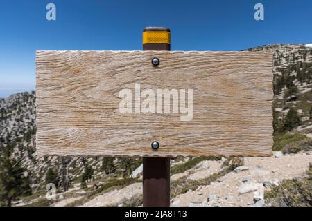 Blank weathered wood sign with mountain background. Stock Photo