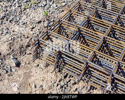 reinforcing mesh lies on the ground, waiting to rise to the mounting horizon, selective focus Stock Photo