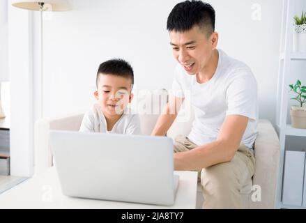 Very happy child playing game online with laptop stay at home. Asian boy  student online learning class study online video call teacher Stock Photo -  Alamy