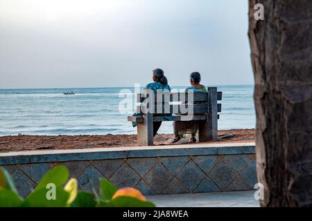 Two Indian women relaxing at beach