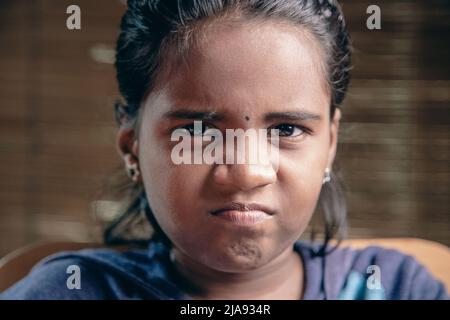 Asian Girl showing frown expression Stock Photo